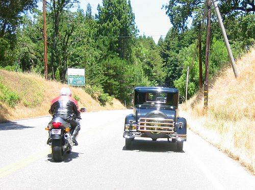 Model A Ford Doing The Twisties With A Sport Bike