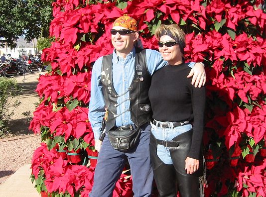 Couple Poses By The Poinsetta Tree